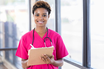 african american nurse holding a clipboard